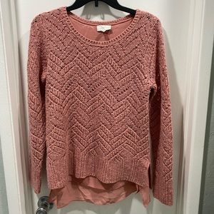 Pink sweater. Has silver threading throughout.